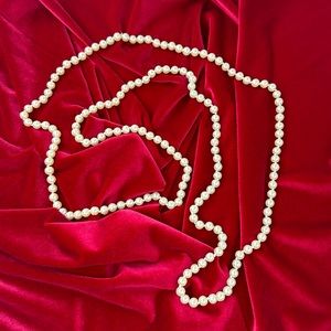 30 inch long hand knotted faux pearls.